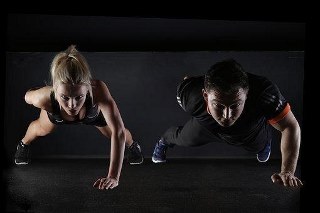 man and women are doing pushups as their regular exercise
