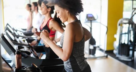 Group of people exercising in a gym cardio training and running increases their endurance
